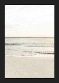 Photograph of calm sea at the beach in light beige tones-5