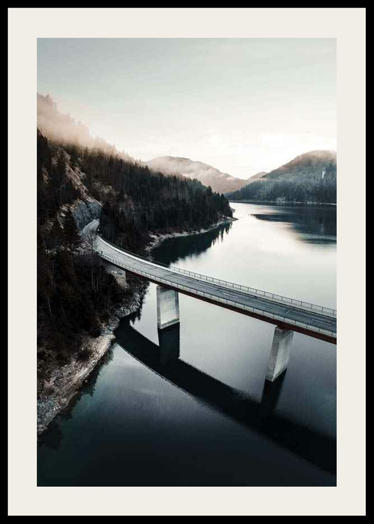 Photographic bridge over calm lake with forested mountains-12