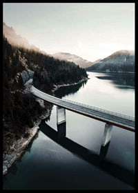 Photographic bridge over calm lake with forested mountains-6