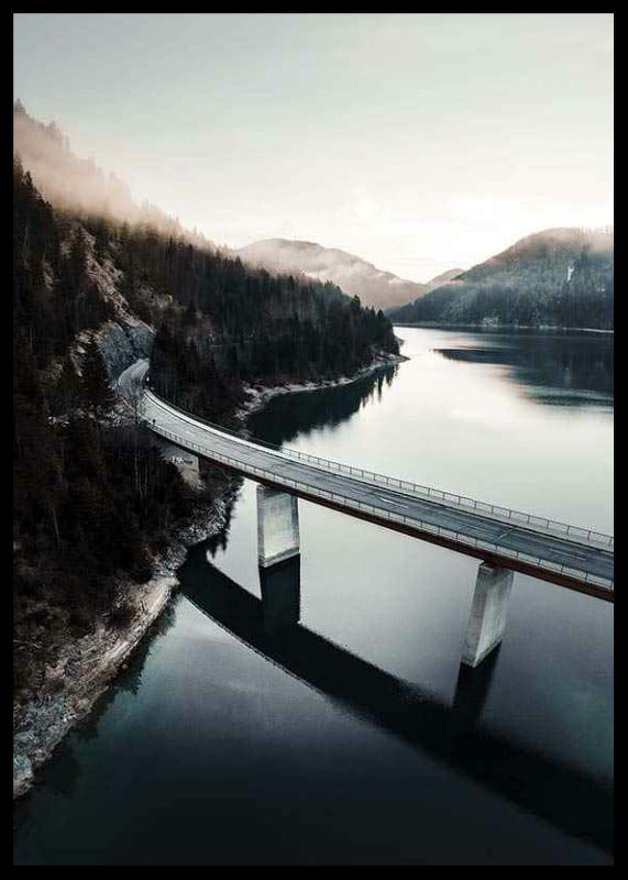 Photographic bridge over calm lake with forested mountains-12