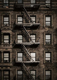 Photographic view of brick building with fire escape in New York-7