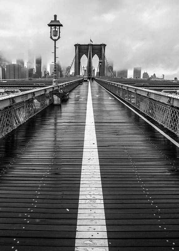 Black and white photograph of Brooklyn Bridge with wet wooden surface-12