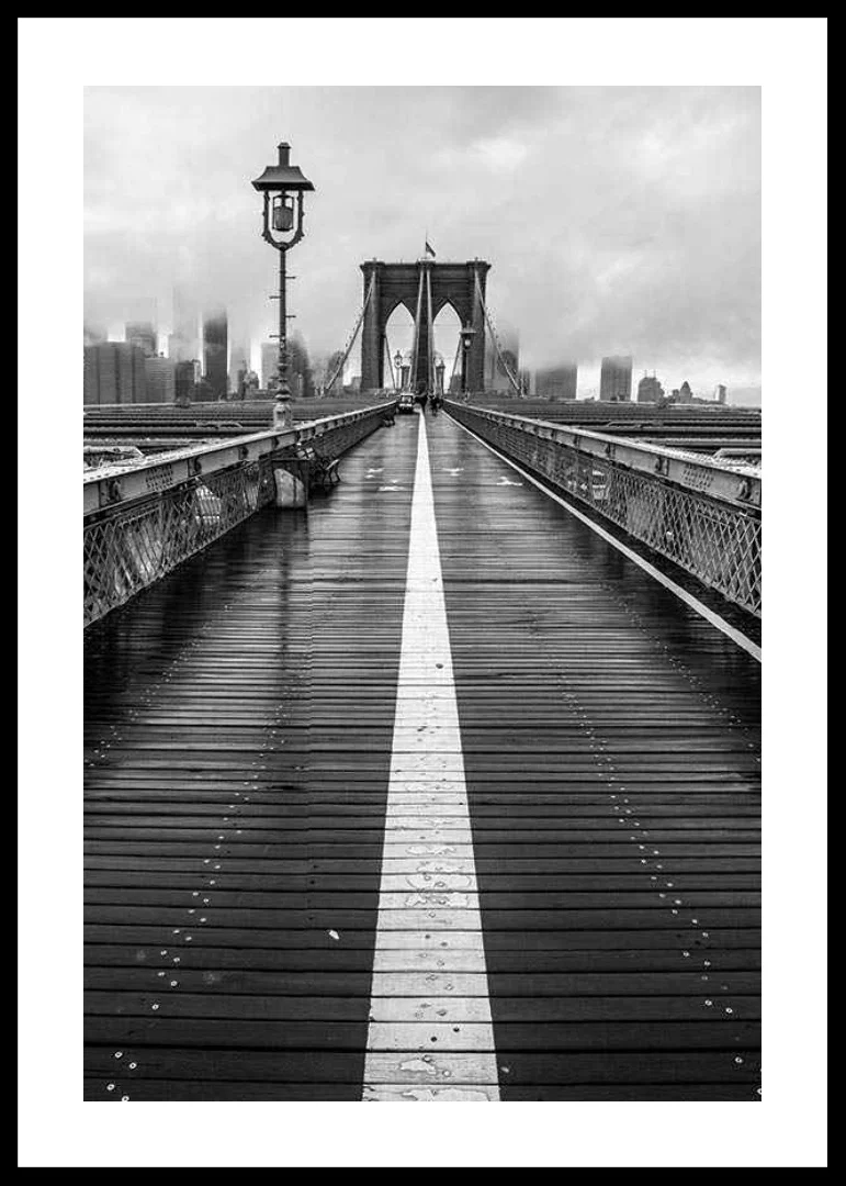 Black and white photograph of Brooklyn Bridge with wet wooden surface-12