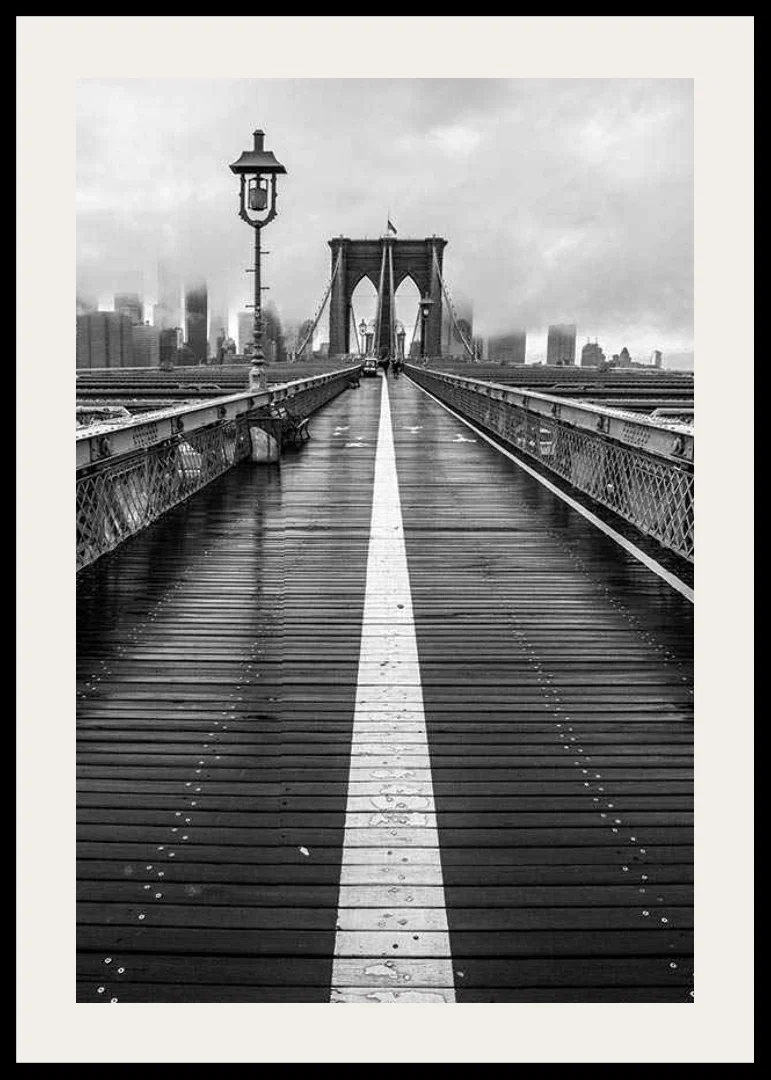 Black and white photograph of Brooklyn Bridge with wet wooden surface-12