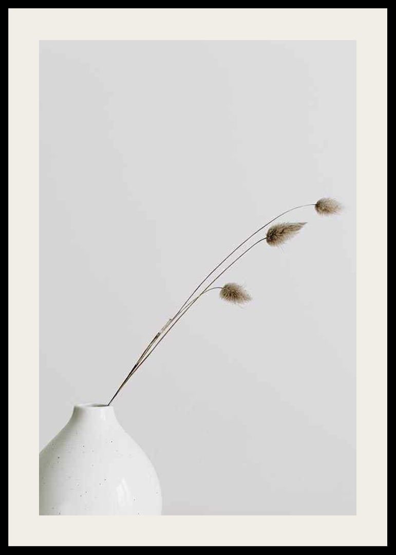 Photograph of dried blades of grass in white vase against light background-12