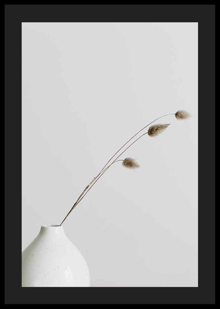 Photograph of dried blades of grass in white vase against light background-12