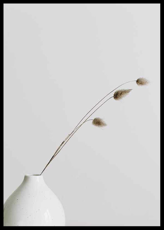 Photograph of dried blades of grass in white vase against light background-12