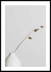 Photograph of dried blades of grass in white vase against light background-0