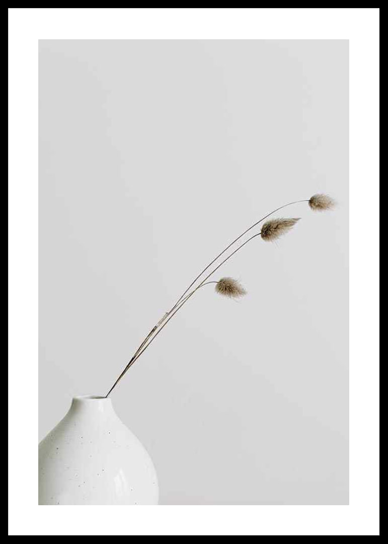 Photograph of dried blades of grass in white vase against light background-12