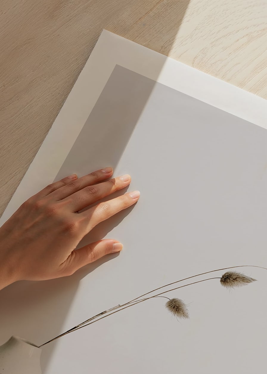 Photograph of dried blades of grass in white vase against light background-12