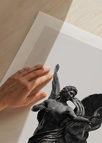 Black and white close-up of Eros statue with bow and wings-9
