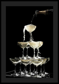 Photograph of champagne tower with flowing bubbles against black background-0