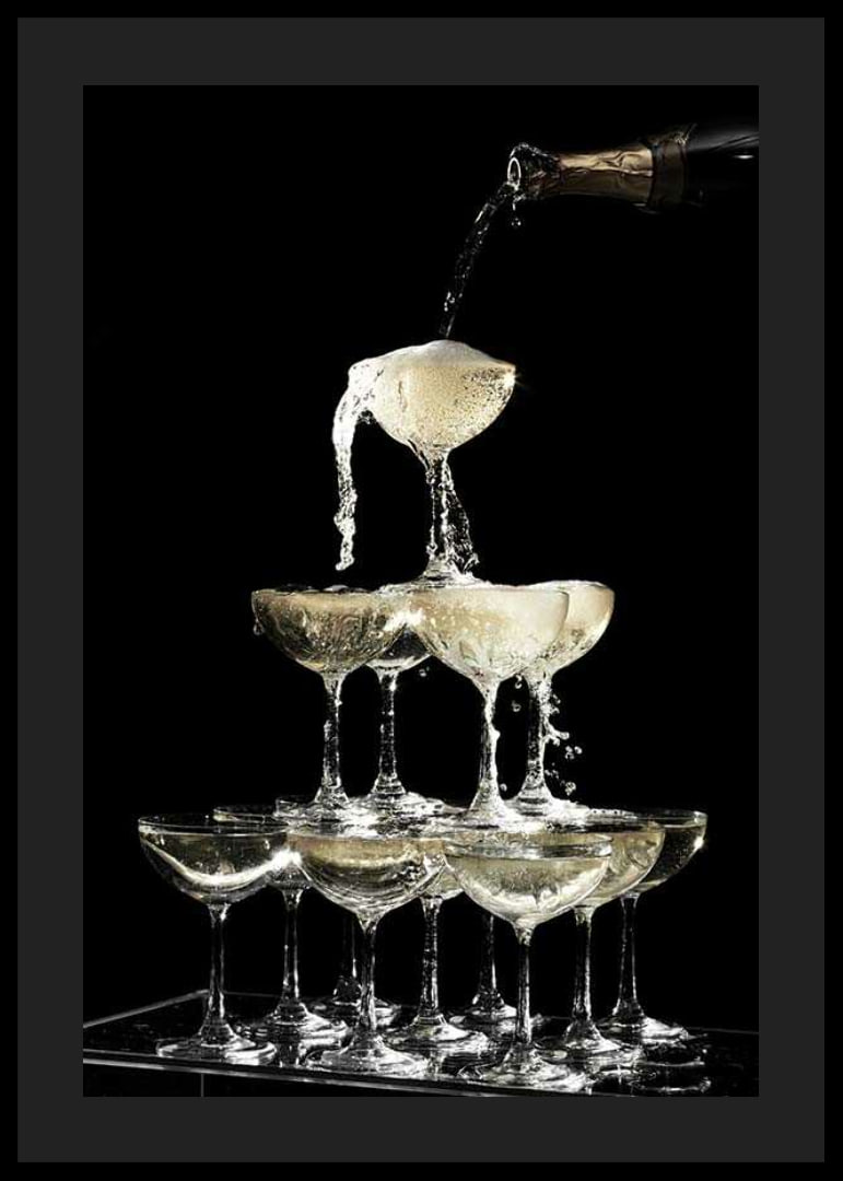 Photograph of champagne tower with flowing bubbles against black background-12