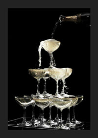 Photograph of champagne tower with flowing bubbles against black background-1