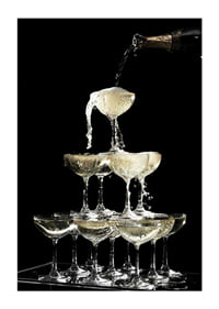 Photograph of champagne tower with flowing bubbles against black background-3