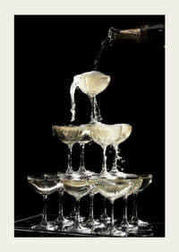 Photograph of champagne tower with flowing bubbles against black background-3