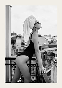 Black and white photograph of woman in swimsuit on balcony-3