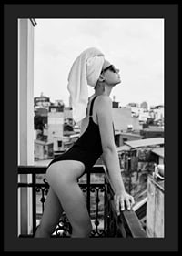 Black and white photograph of woman in swimsuit on balcony-4