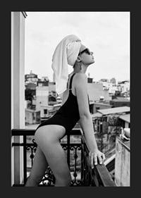 Black and white photograph of woman in swimsuit on balcony-5