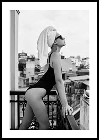 Black and white photograph of woman in swimsuit on balcony-0
