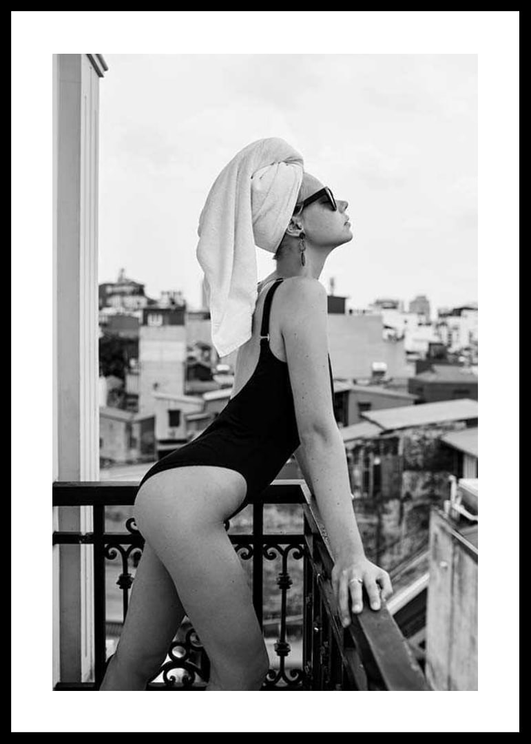 Black and white photograph of woman in swimsuit on balcony-12