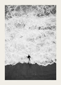 Black and white photo of person running towards wavy sea-3