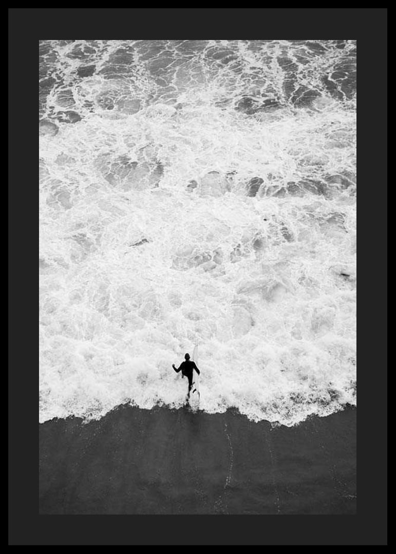 Black and white photo of person running towards wavy sea-12