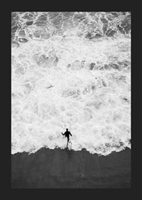 Black and white photo of person running towards wavy sea-5