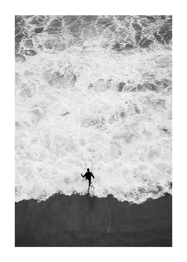 Black and white photo of person running towards wavy sea-12