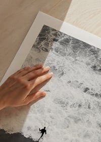 Black and white photo of person running towards wavy sea-9