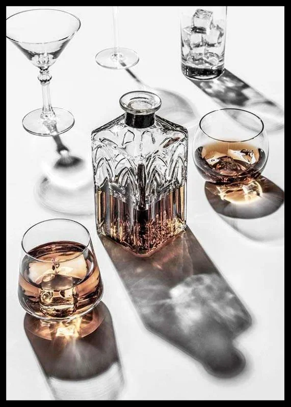 Photograph of whiskey decanter and glass with ice on light surface-12