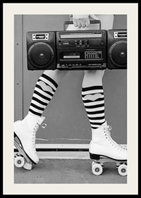Black and white photo of legs in roller skates and striped socks-2
