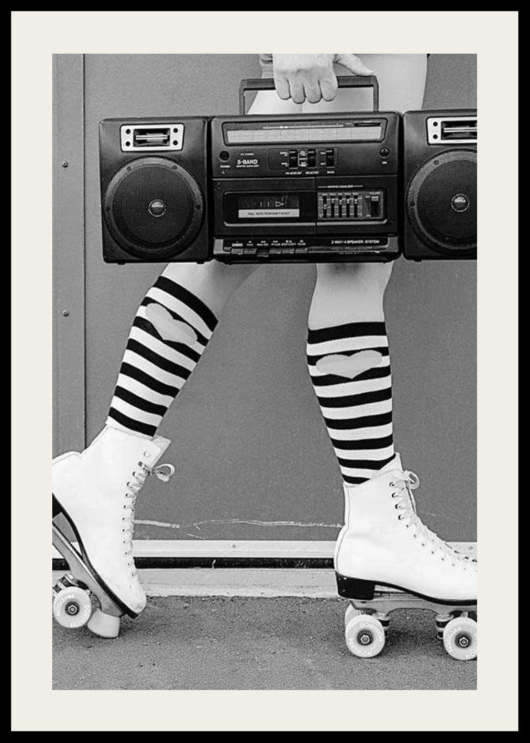 Black and white photo of legs in roller skates and striped socks-12