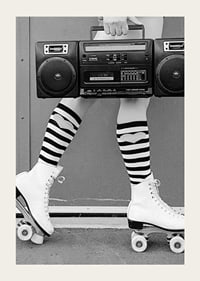 Black and white photo of legs in roller skates and striped socks-3