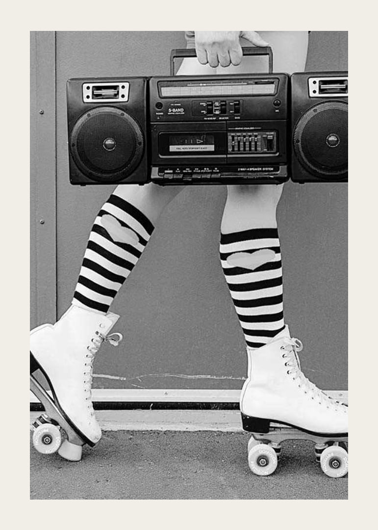 Black and white photo of legs in roller skates and striped socks-12