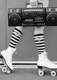 Black and white photo of legs in roller skates and striped socks-7