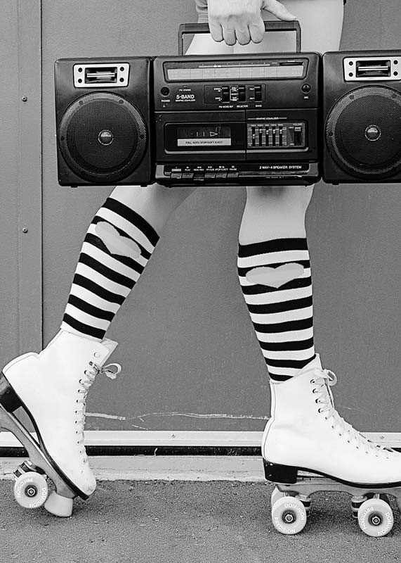 Black and white photo of legs in roller skates and striped socks-12
