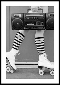 Black and white photo of legs in roller skates and striped socks-0
