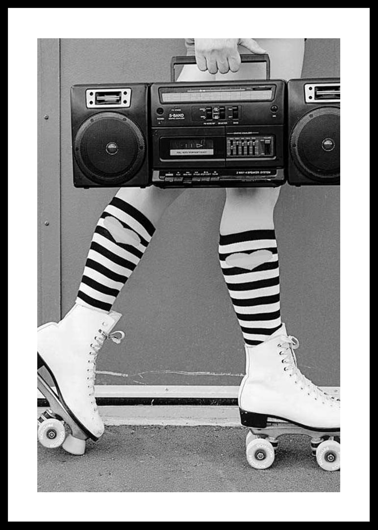 Black and white photo of legs in roller skates and striped socks-12