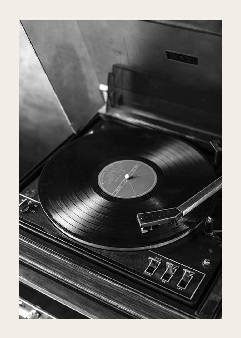 Black and white close-up of classic vinyl player with record-12