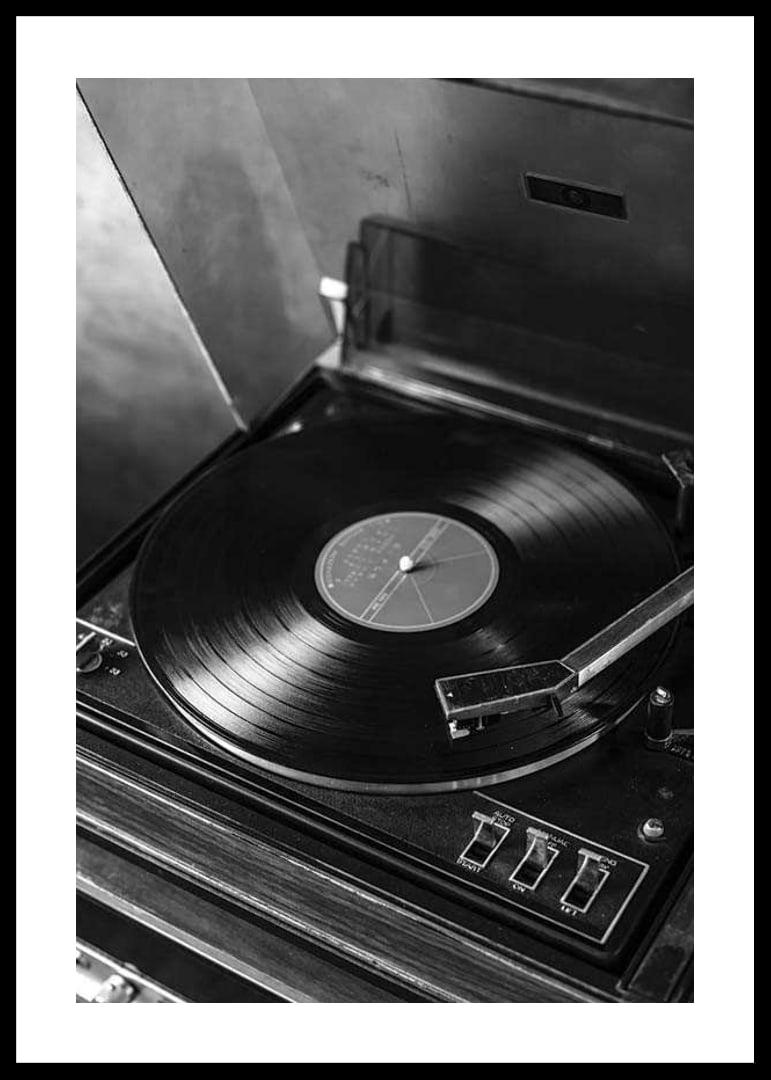 Black and white close-up of classic vinyl player with record-12