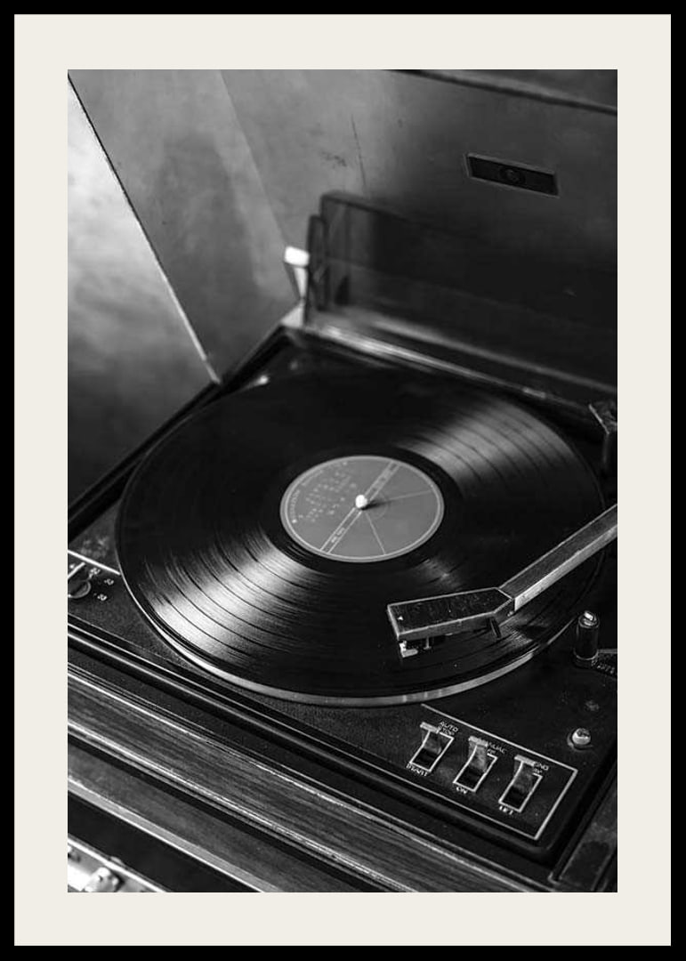 Black and white close-up of classic vinyl player with record-12