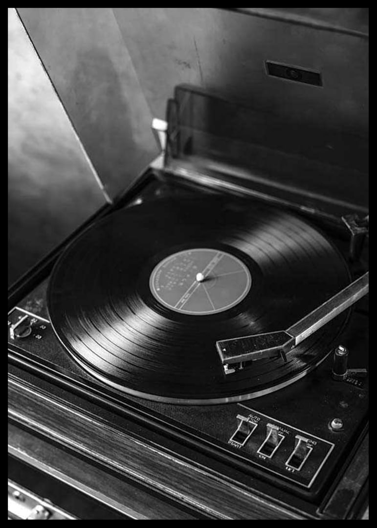 Black and white close-up of classic vinyl player with record-12