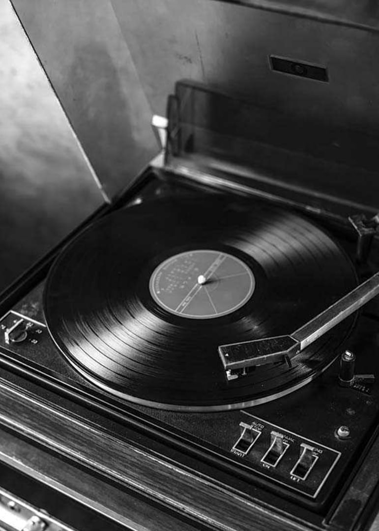 Black and white close-up of classic vinyl player with record-12