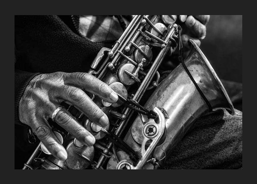 Black and white photo of hands playing a saxophone-12