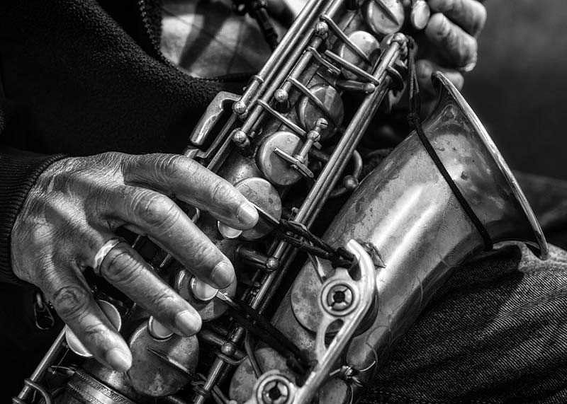Black and white photo of hands playing a saxophone-12