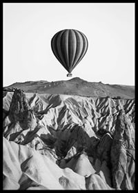 Black and white photograph of hot air balloon over dramatic landscape-6
