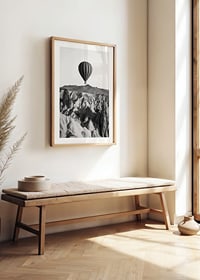Black and white photograph of hot air balloon over dramatic landscape-8