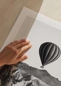 Black and white photograph of hot air balloon over dramatic landscape-9