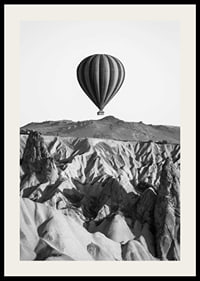 Black and white photograph of hot air balloon over dramatic landscape-2